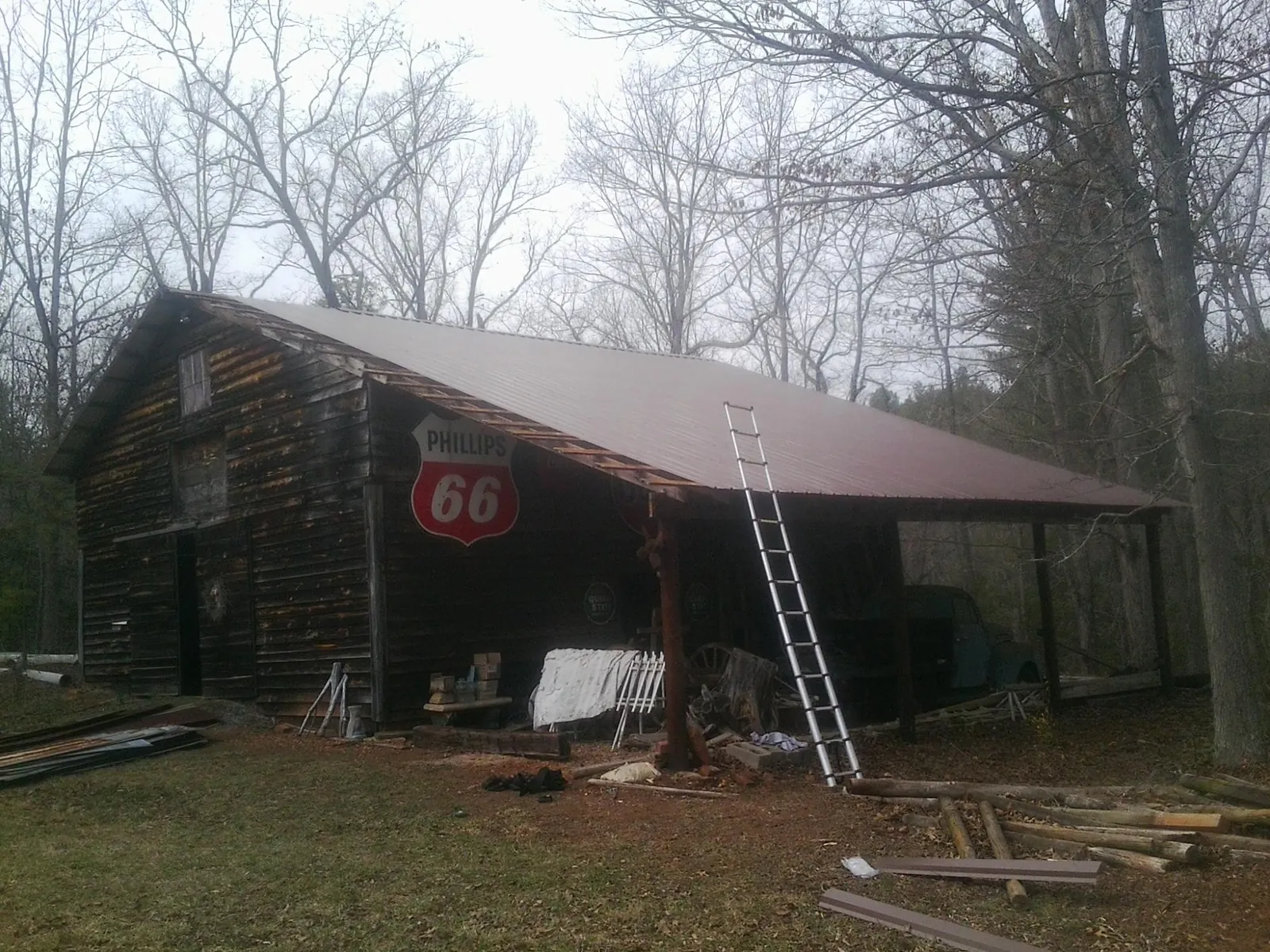 New metal roof on an open sided timber barn with a vintage sign in Roanoke